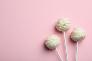 Sweet cake pops on pink background, flat lay. Space for text
