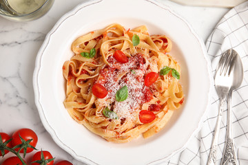 Flat lay composition with tasty pasta on white marble table