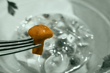 delicious mushroom on a fork , black and white