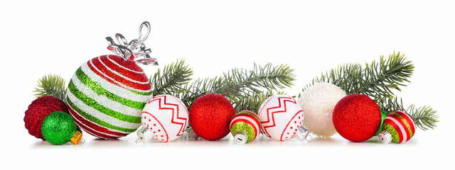 Christmas border of red, green and white ornaments with branches. Side view isolated on a white background.