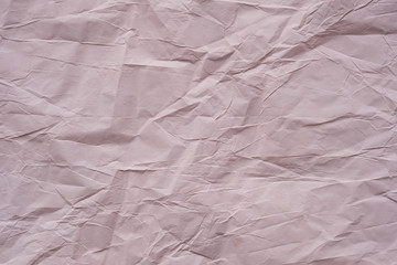 Crumpled paper texture of brown pink color. Abstract paper background.