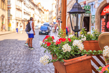 Fototapeta na wymiar City summer landscape - view of street flowers in the historic district of Malа Strana (Little Side), in the city of Prague, Czech Republic