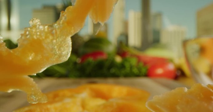 Close up of cutting a yellow pepper, pushing in through pepper ring, cooking process, tasty and vibrant image, sharp knife, chopping a yellow paprika, cityscape background