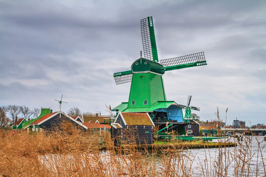 Rural landscape - view of the windmills on a cloudy winter day at the Zaanse Schan in the neighbourhood of Zaandam town, near Amsterdam, Netherlands