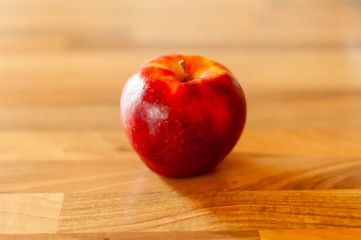 red apple on wooden table