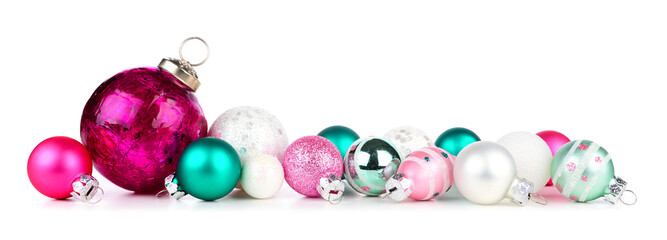 Christmas border of pink, teal and white ornaments. Side view isolated on a white background.