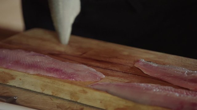 arranging  fish fillet in a chopping board. extreme close up