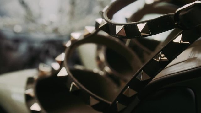  Women's shoes and a crown lie on a mirror