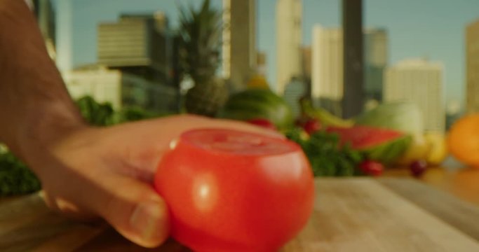 Close up of cutting a tomato, cooking process, tasty and vibrant image, sharp knife, chopping a tomato, cityscape background
