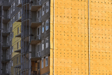 Construction of a high residential building and insulation of its external wall with special heat-insulating material. Home insulation technologies