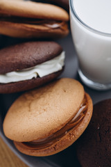 Close up Traditional chocolate and Pumpkin Whoopie pies made with vanilla cream cheese. Background for bakeries, cafes, restaurants