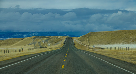 Interstate freeway runs across the Montana countryside towards the distant hills