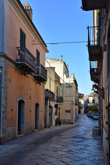 Fototapeta na wymiar Venosa, Italy, 10/27/2019. A narrow street among the old houses of a medieval village