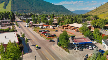 Panoramic aerial view of Jackson Hole homes and beautiful mountains on a summer morning, Wyoming - obrazy, fototapety, plakaty