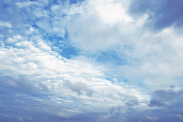 Dark and white clouds on blue sky