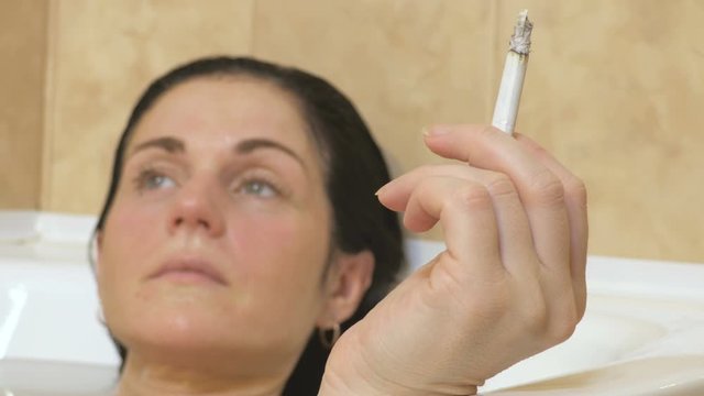 Woman smoking in Bathtub.Stock footage video