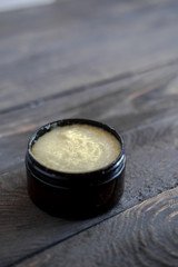 Dark brown cosmetic jar with body scrub