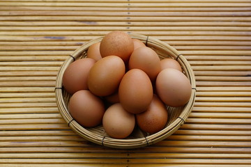 Eggs in basket with wood table background