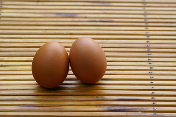 Eggs in basket with wood table background