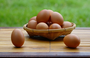 Eggs in basket with wood table background