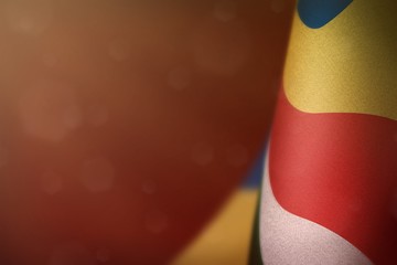 Seychelles flag for honour of veterans day or memorial day. Glory to the Seychelles heroes of war concept on red dark velvet background.