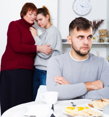 Upset man having problems in relationship with family
