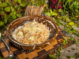 Delicious buckwheat noodles with bacon and seafood in a craft plate