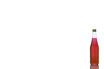 One small glass bottle with red liquid stands on a mirror surface on a white background to the right.