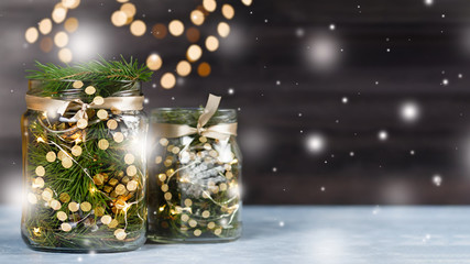 Christmas decoration handmade in glass jar with lights, fir tree, pine cones. Christmas still life...