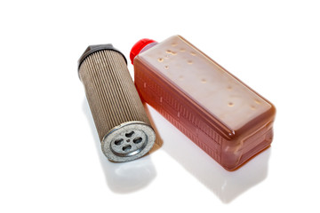 Bottle with industrial oil and oil filter on a white background.