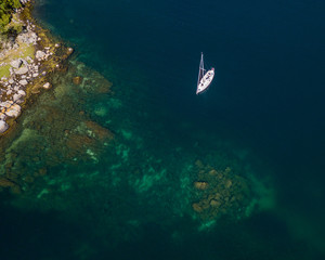 Sailboat anchored in beautiful blue water