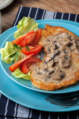 Crispy fried homemade potato pancakes with mushroom sauce.