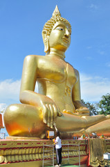 Giant gold buddha statue at the Wat Pra Yai temple (Big Buddha Hill) - Pattaya, Thailand.