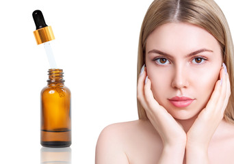 Cosmetics oil in bottle near beautiful face of young woman.