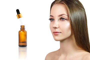 Obraz na płótnie Canvas Cosmetics oil in bottle near beautiful face of young woman.