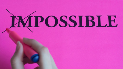 Motivational inscription impossible is possible on a pink background. Coaching, trainings,...