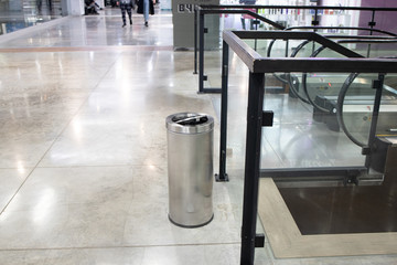 Close up of garbage bin. Metall trash can in mall. Separate garbage collection. Modern interior of...