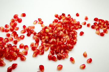 heart made of pomegranate seeds isolated on white