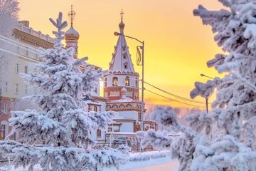 Foto op Canvas Winter sunset landscape of frosty trees, white snow in city park. Trees covered with snow in Siberia, Irkutsk near lake Baikal. Extremely cold winter © Elena Sistaliuk