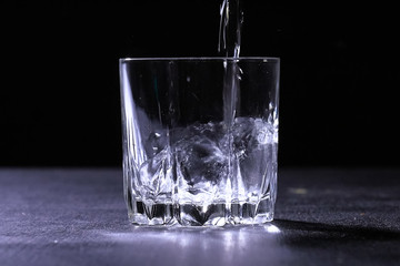 transparent glass on the table in which water is poured.
