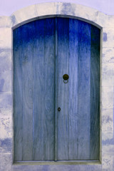 Blue wooden door in stone arch doorway