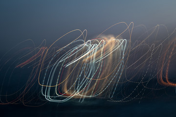 Abstract swirls and waves of light against the night sky. Drawing light freezelight. long exposure