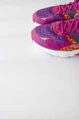 Sport sneakers on the white background with copy space for text. Sport concept. Accessories for fitness and running, portrait orientation.