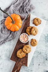 Pumpkin spice truffle cookies on marble and wood serving board