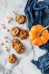 Pumpkin spice cookies on marble background with pumpkin and napkin 