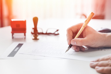 Lawyer working in office. Notary signs document