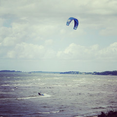 A lonely kite surfer surfing the waves of the sea Öresund between Sweden and Denmark.