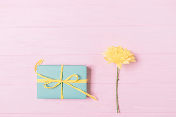 Top view gift box and fresh flower on pink background