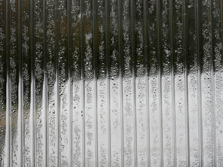 Wet condensation on a glass inside greenhouse. Abstract background texture.