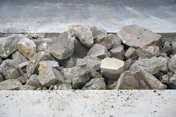 A heap of broken asphalt plates in the middle of a road. A construction site in Berlin-Germany.